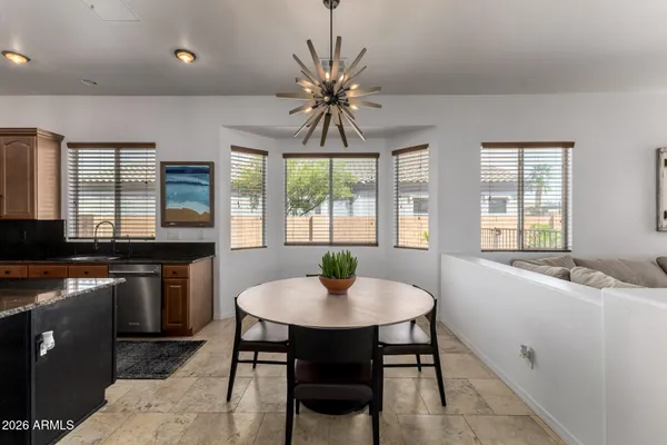 a large bathroom with a granite countertop double vanity sink a bathtub and window