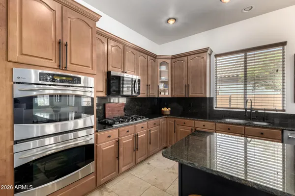 a bedroom that has a bed and a chair in it