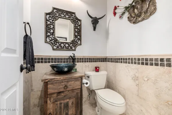 a bathroom with a granite countertop sink a toilet and shower