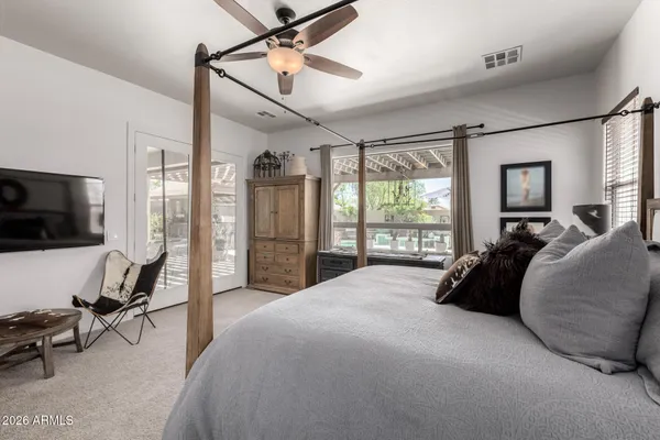 a living room with furniture a flat screen tv and a large window