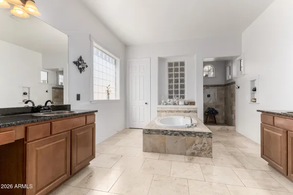 a view of a porch with chairs and floor to ceiling window