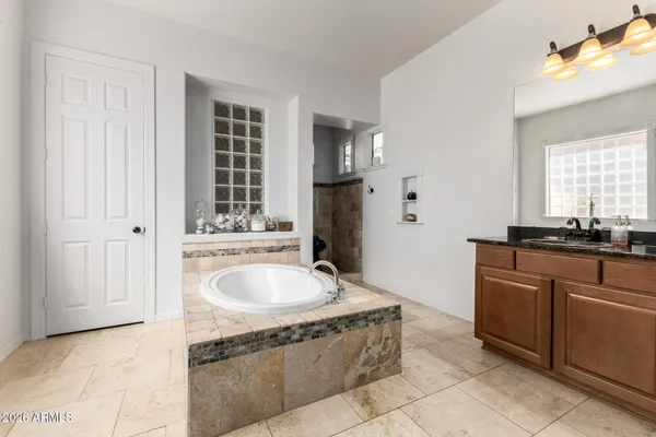 a view of a patio with table and chairs with wooden floor and fence
