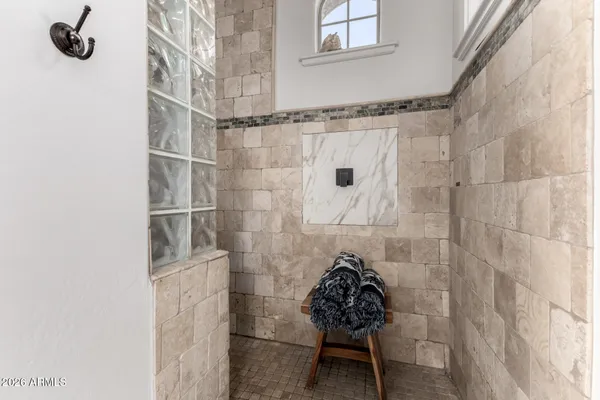a view of a chair and table in backyard of the house