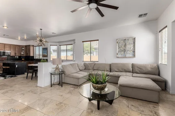 a large bed sitting in a bedroom next to a window