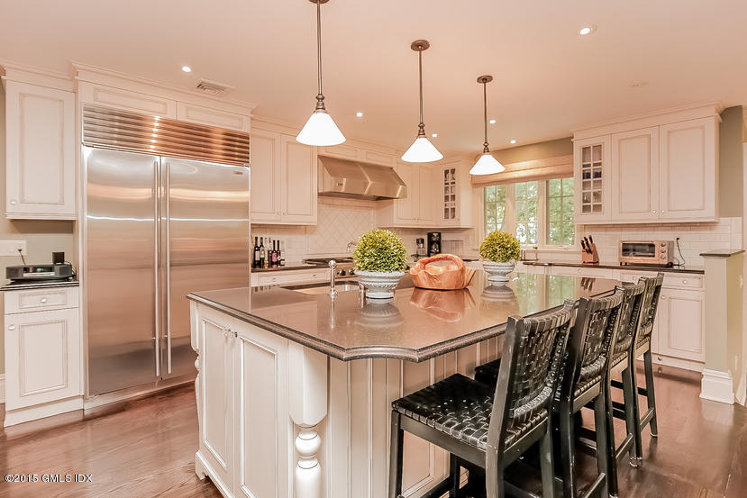 42 Owenoke Way Riverside, CT 06878 - Photo 8 of 19 a kitchen with stainless steel appliances granite countertop a sink a stove a table and chairs