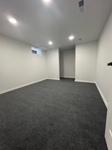 an empty room with a space and windows