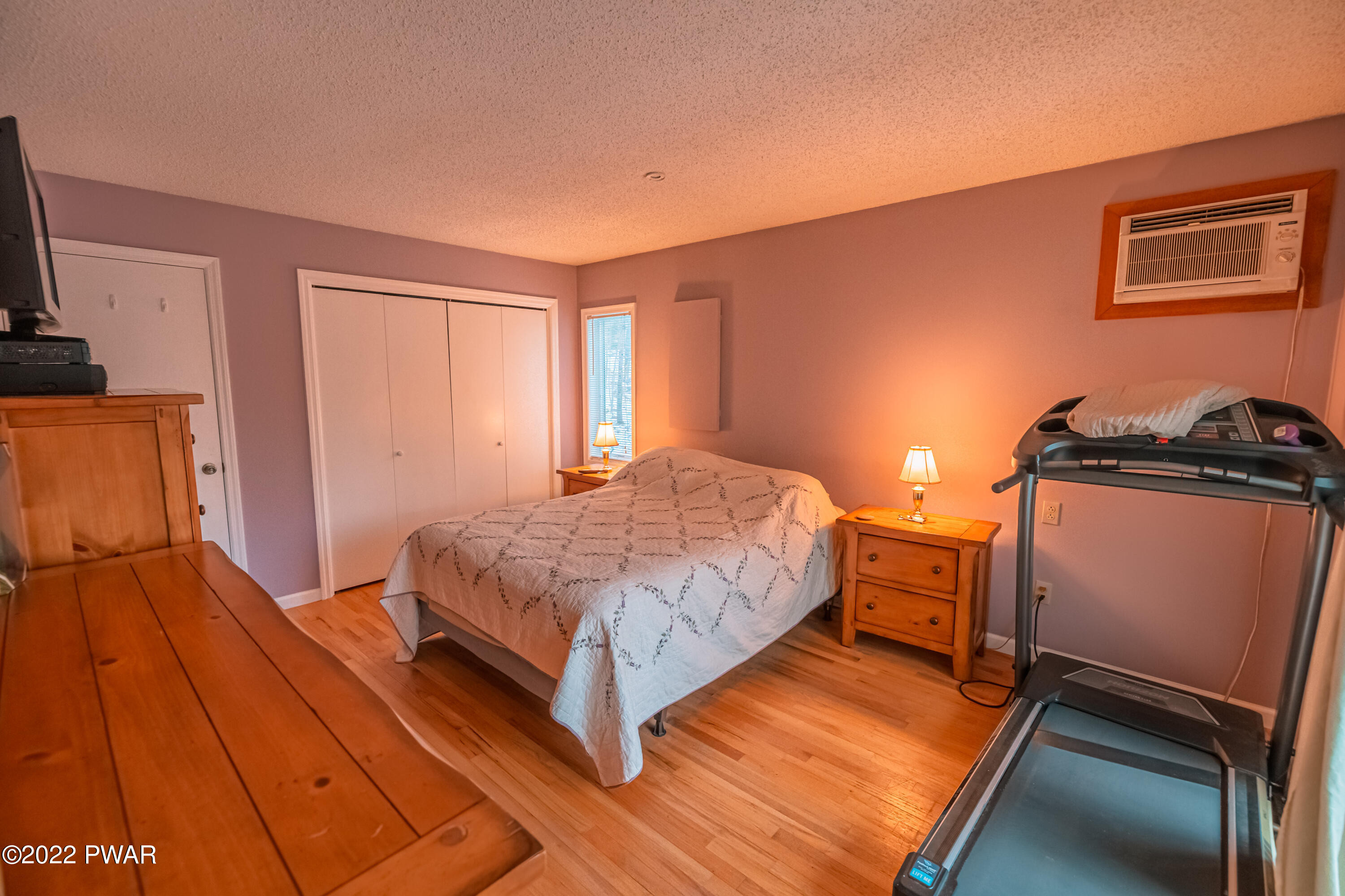 4141 Winchester Way Bushkill, PA 18324 - Photo 26 of 75 a bedroom with a bed and wooden floor