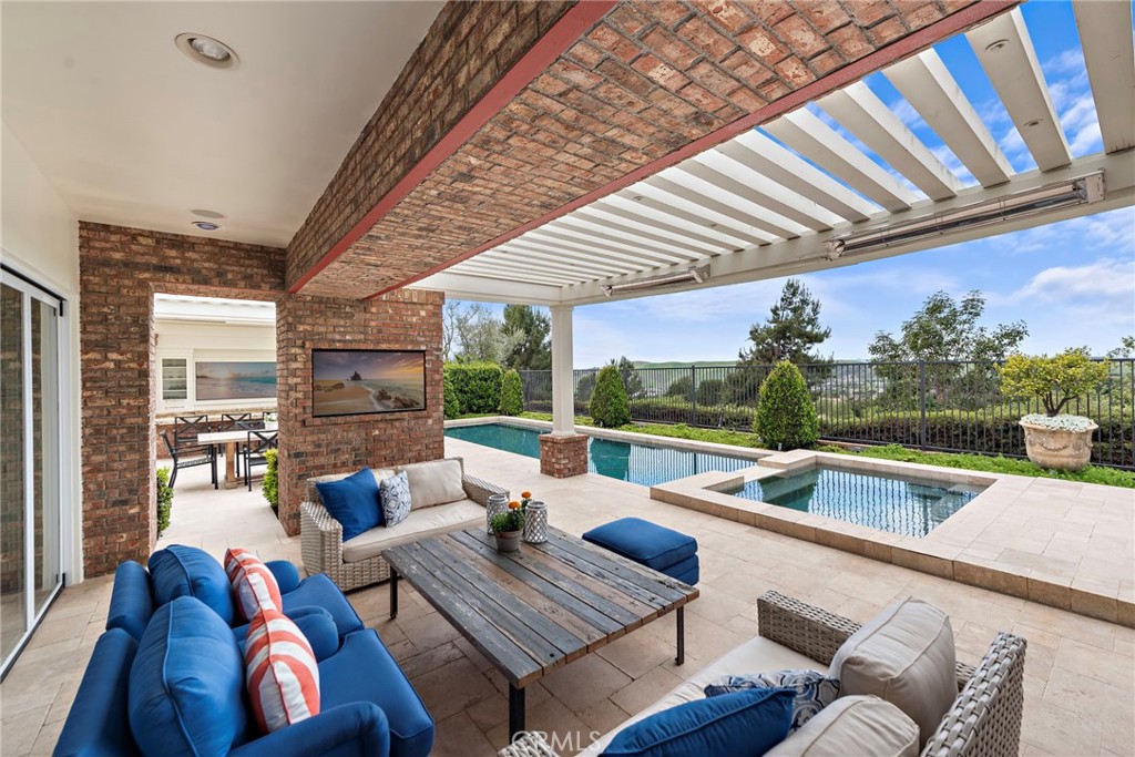 15 Starlight Ladera Ranch, CA 92694 - Photo 18 of 36 a view of a patio with couches chairs dining table and chairs with wooden floor