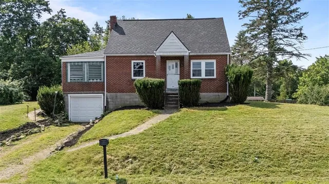 a front view of a house with a yard and porch
