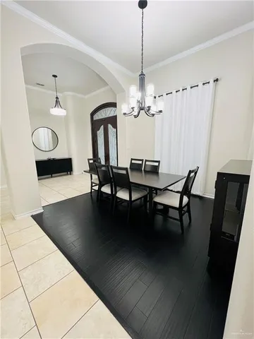 a view of a dining room with furniture and chandelier