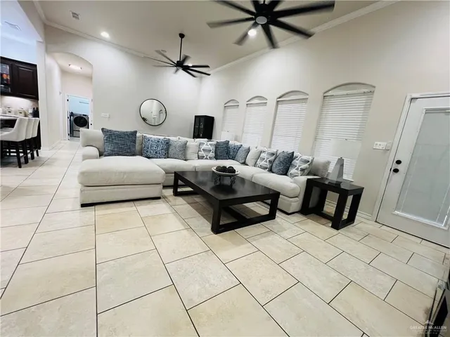 a living room with furniture and a large mirror