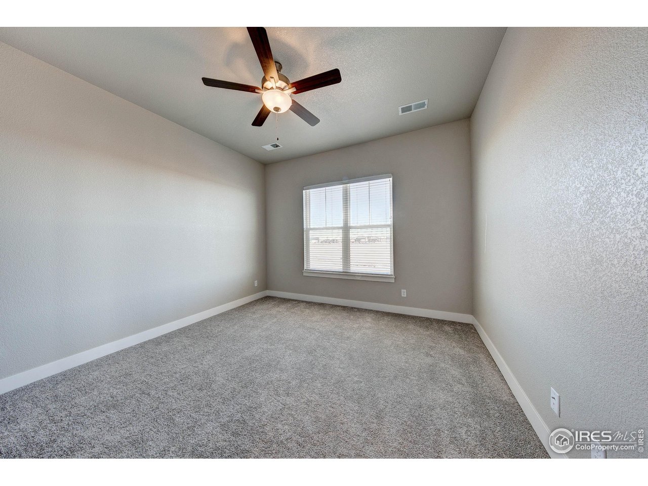 265 High Point Drive, Unit 201 Longmont, CO 80504 - Photo 11 of 26 a view of an empty room with a window