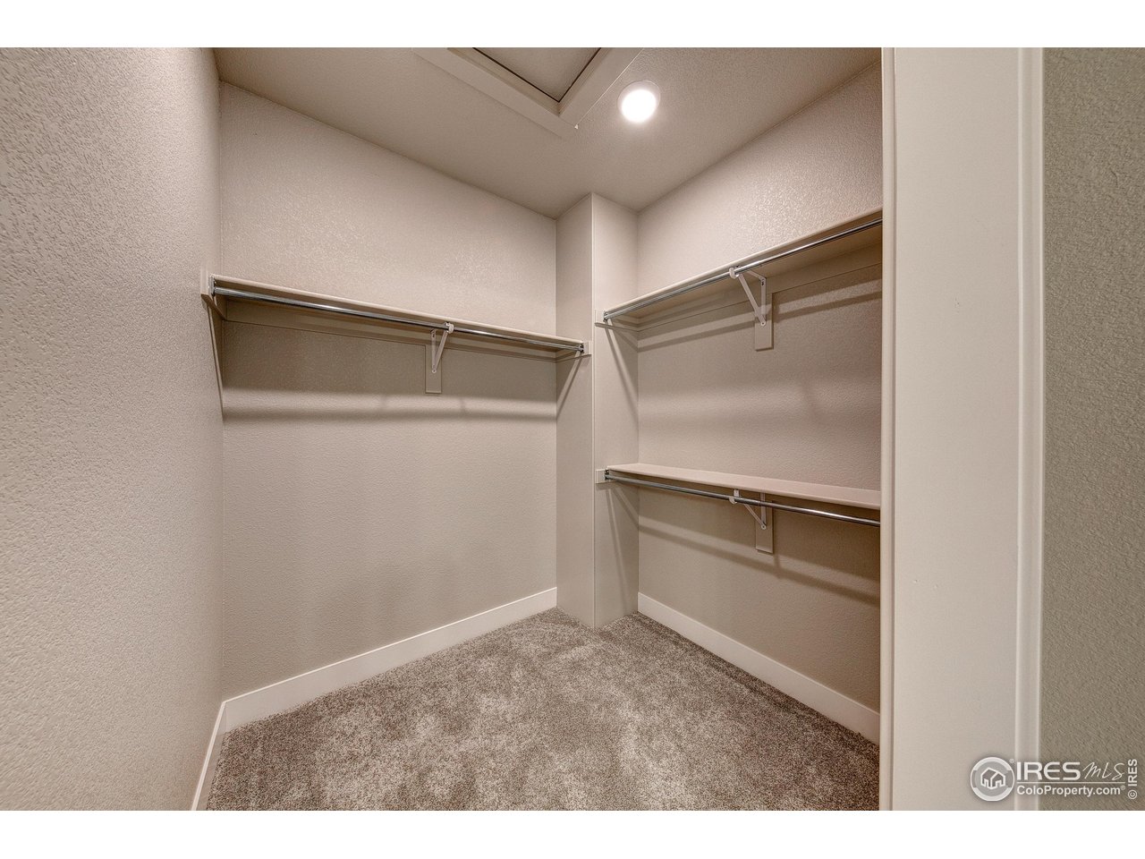 265 High Point Drive, Unit 201 Longmont, CO 80504 - Photo 12 of 26 a kitchen with white cabinets and a refrigerator