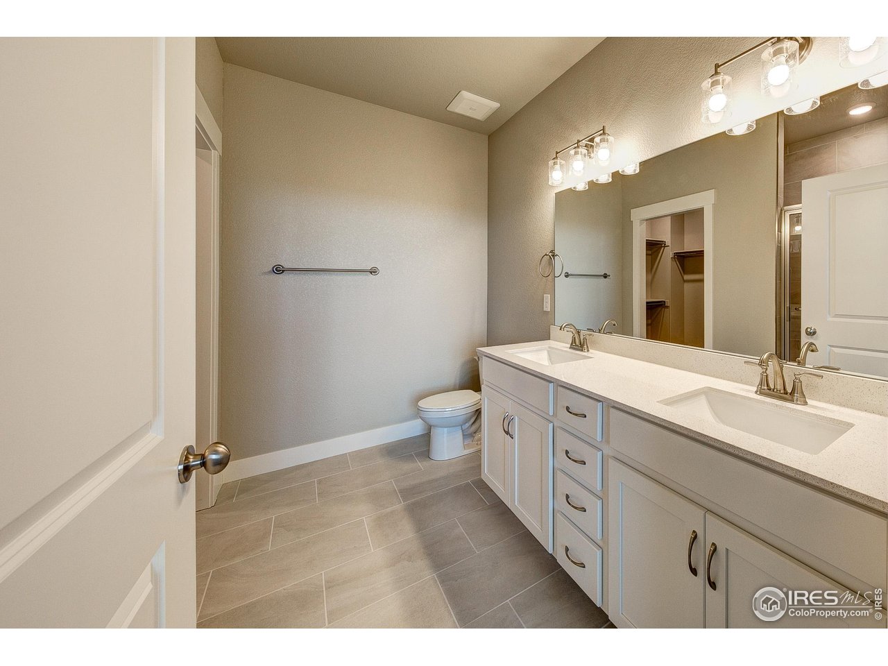 265 High Point Drive, Unit 201 Longmont, CO 80504 - Photo 13 of 26 a bathroom with a double vanity sink toilet and a mirror