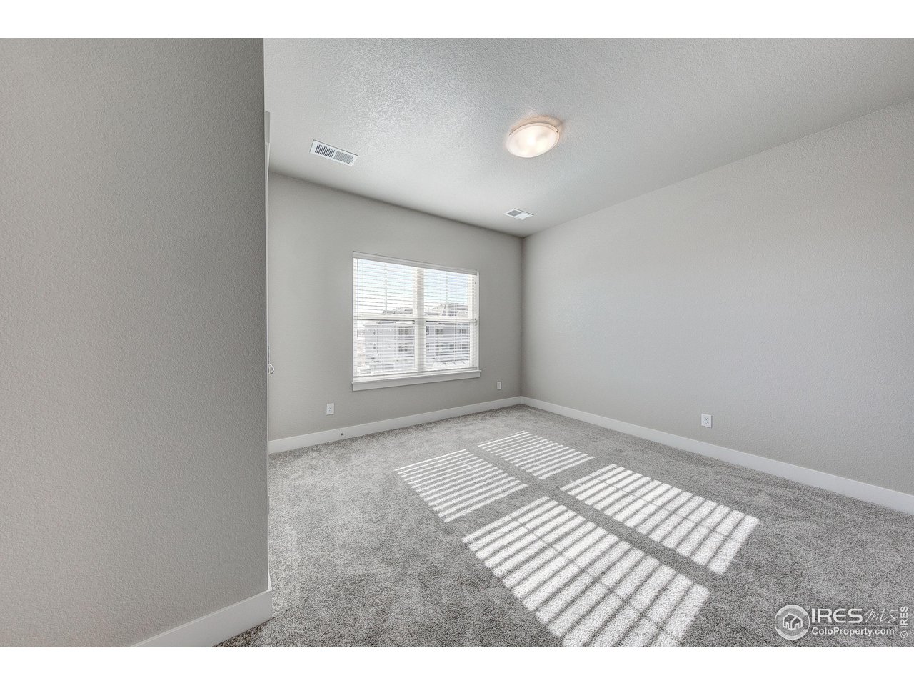 265 High Point Drive, Unit 201 Longmont, CO 80504 - Photo 15 of 26 an empty room with wooden floor and windows