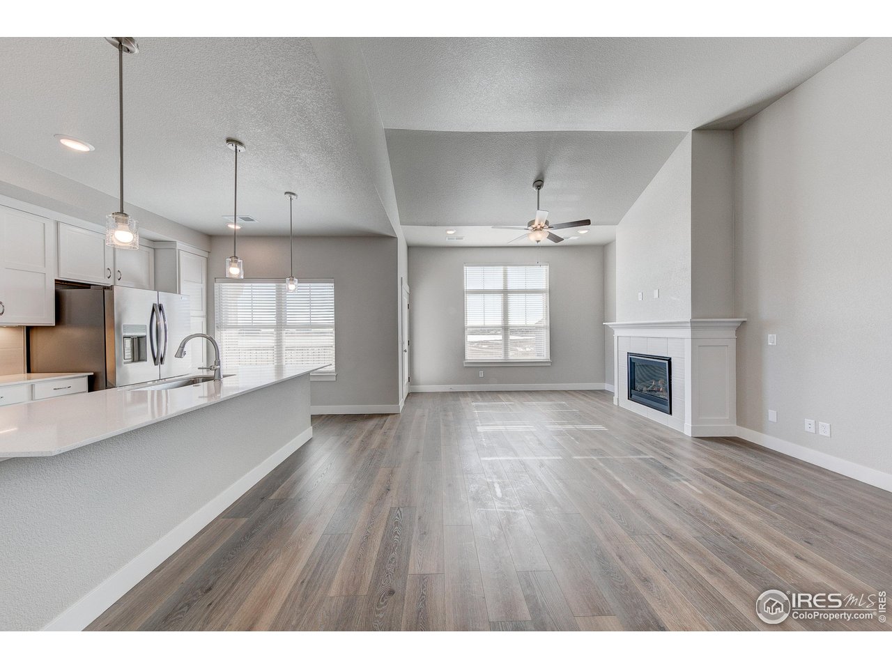 265 High Point Drive, Unit 201 Longmont, CO 80504 - Photo 8 of 26 a view of a kitchen with wooden floor and a kitchen