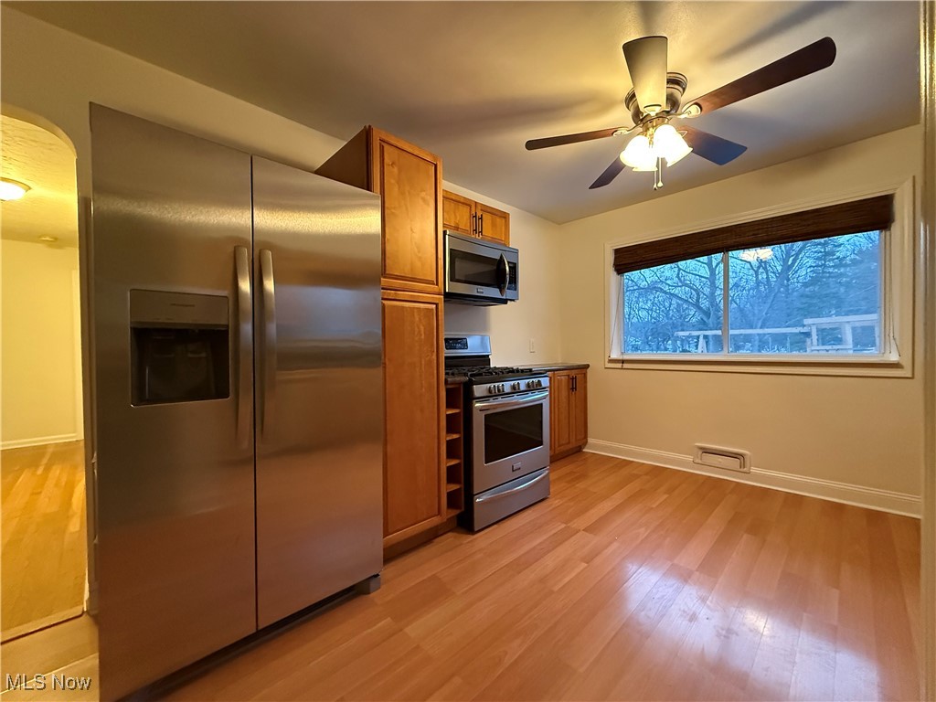 6290 Crossview Road Independence, OH 44131 - Photo 8 of 24 Kitchen with stainless steel appliances, ceiling fan, and light hardwood / wood-style flooring