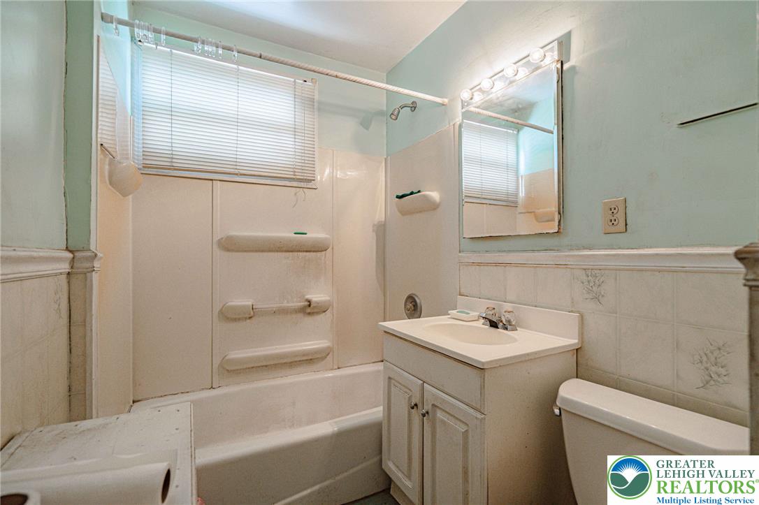 159 West Ridge Street Nesquehoning, PA 18240 - Photo 24 of 55 A well-lit bathroom features a functional vanity and standard tub, ready for daily routines.