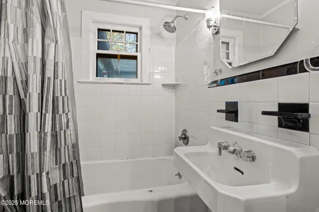 a bathroom with a bathtub and a sink