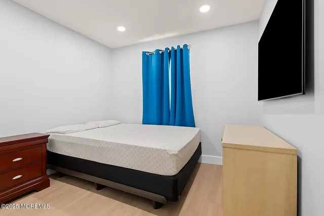 a bed sitting in a bedroom next to a window