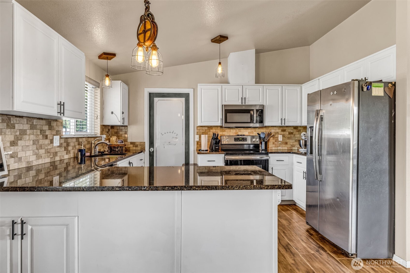 10313 School Land Road Southwest Rochester, WA 98579 - Photo 13 of 40 a kitchen with stainless steel appliances granite countertop a refrigerator a stove and a sink