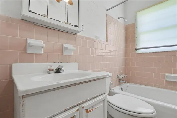 a bathroom with a sink a toilet and bathtub