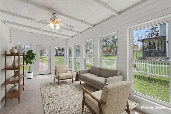 a living room with furniture and a large window