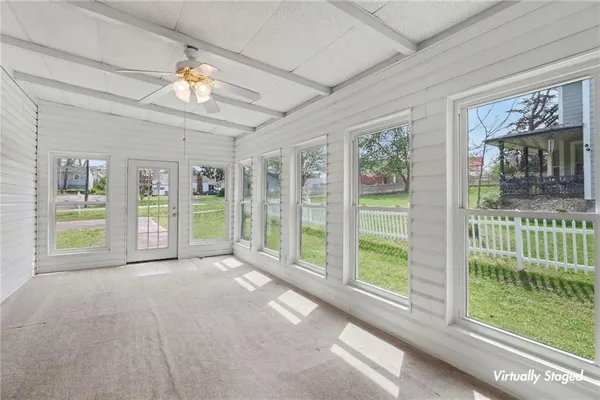 a view of an empty room with a fireplace and a large window