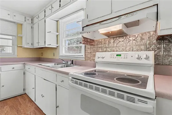 a kitchen with appliances cabinets and a sink