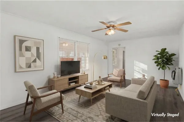 a living room with furniture a ceiling fan and a rug