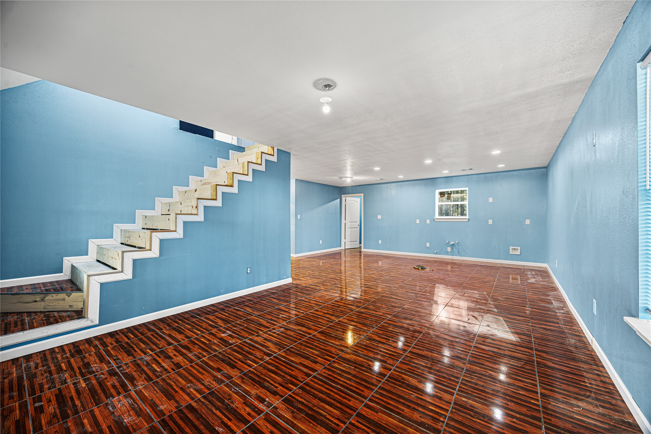 235 Bracewell Cemetery Road Livingston, TX 77351 - Photo 12 of 37 a view of an empty room with stairs and a hardwood