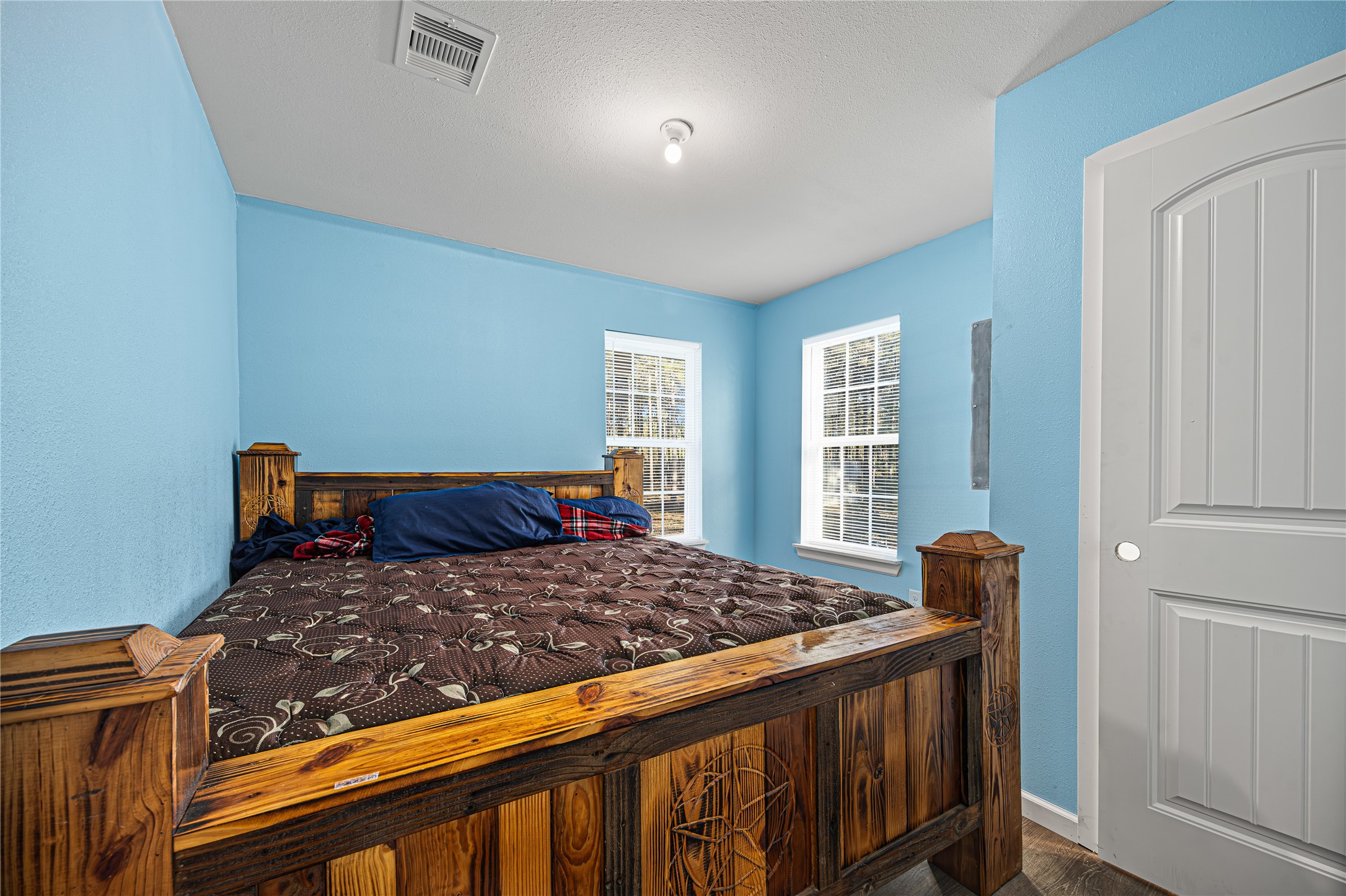 235 Bracewell Cemetery Road Livingston, TX 77351 - Photo 16 of 37 a bedroom with a bed and wooden floor