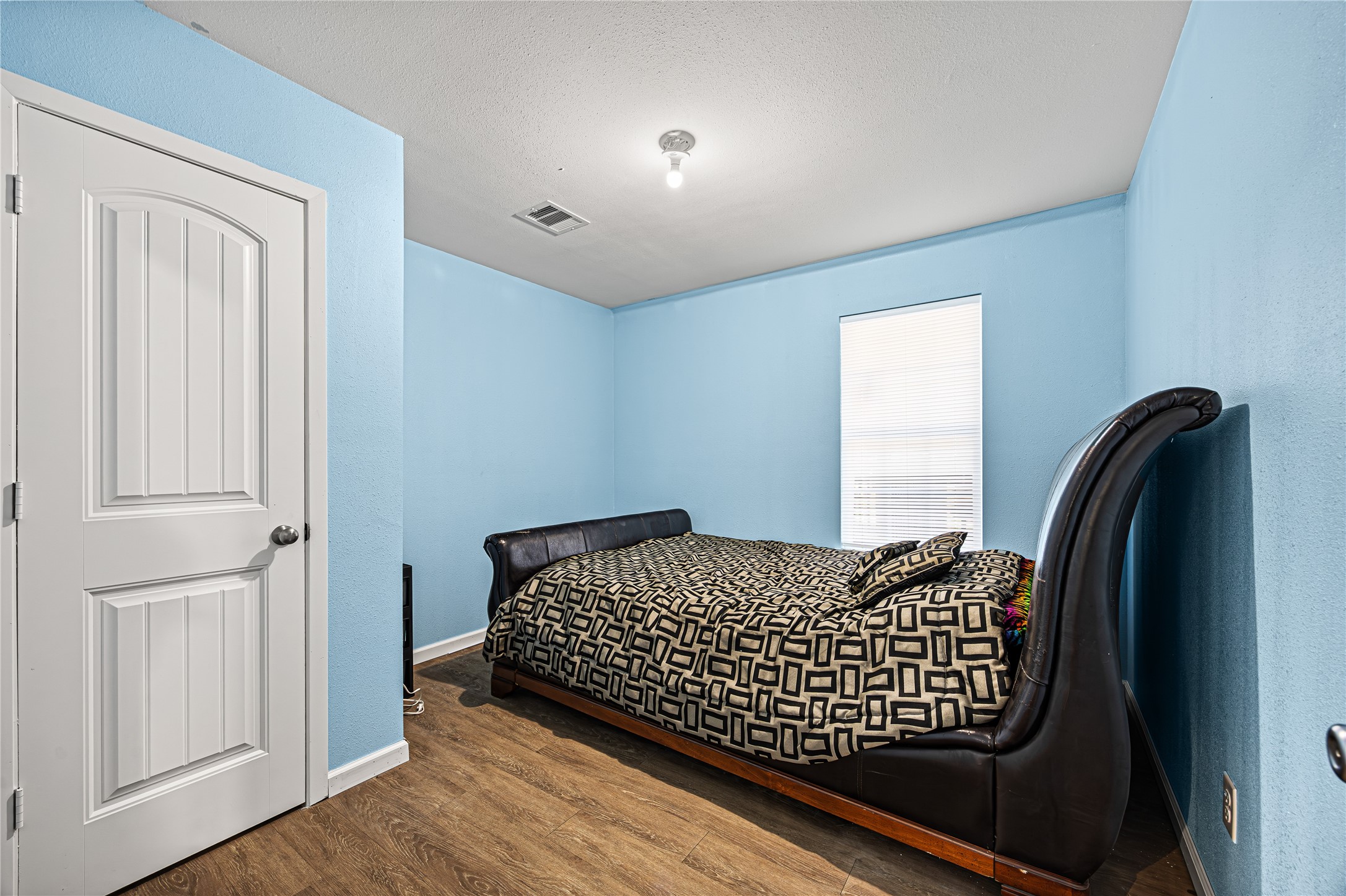 235 Bracewell Cemetery Road Livingston, TX 77351 - Photo 17 of 37 a bedroom with a bed and wooden floor