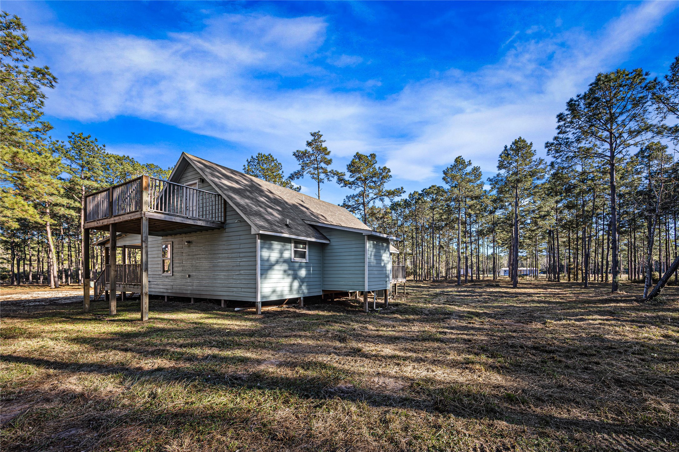 235 Bracewell Cemetery Road Livingston, TX 77351 - Photo 2 of 37 a front view of a house with a garden