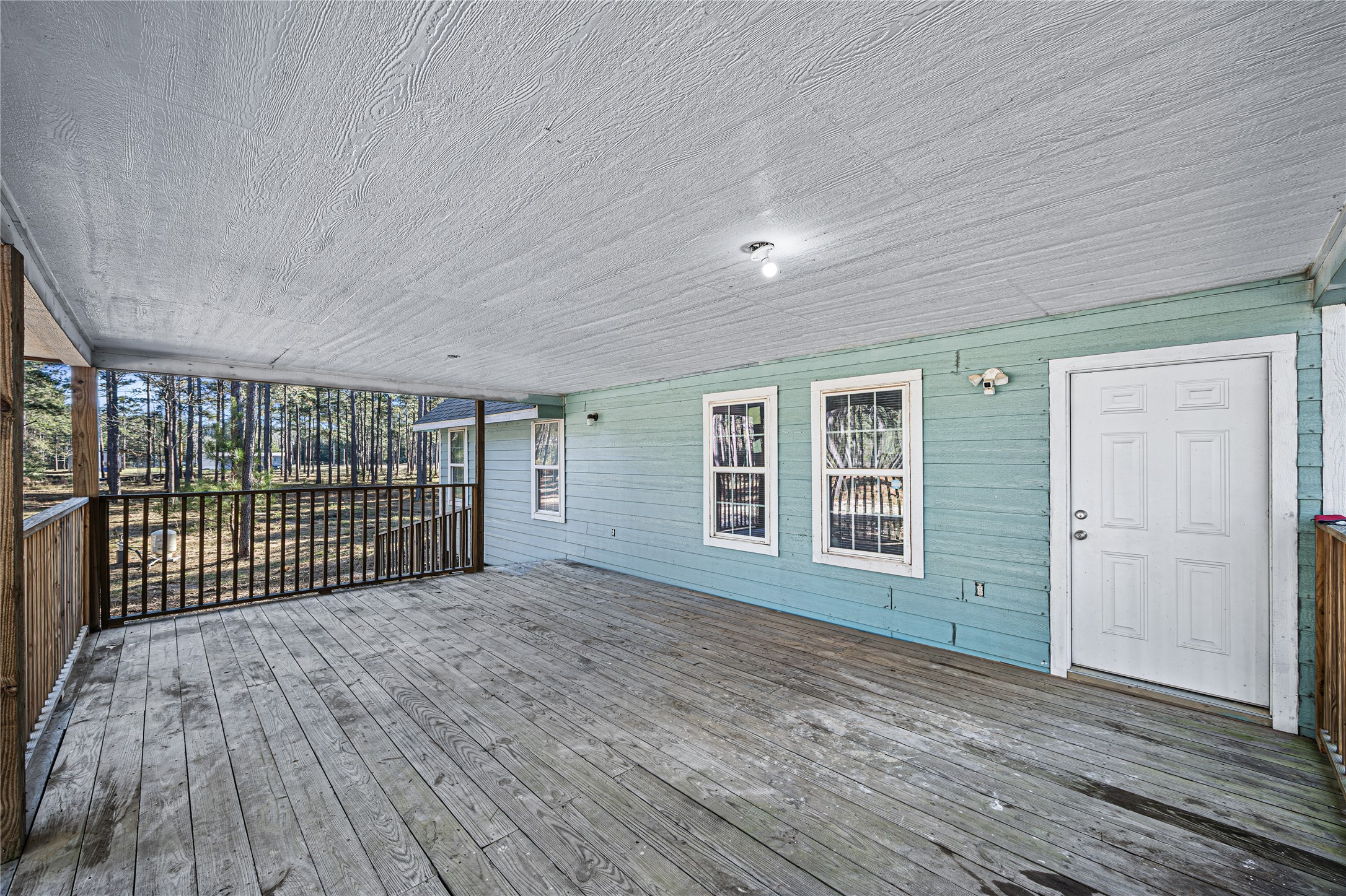 235 Bracewell Cemetery Road Livingston, TX 77351 - Photo 9 of 37 an empty room with wooden floor and windows