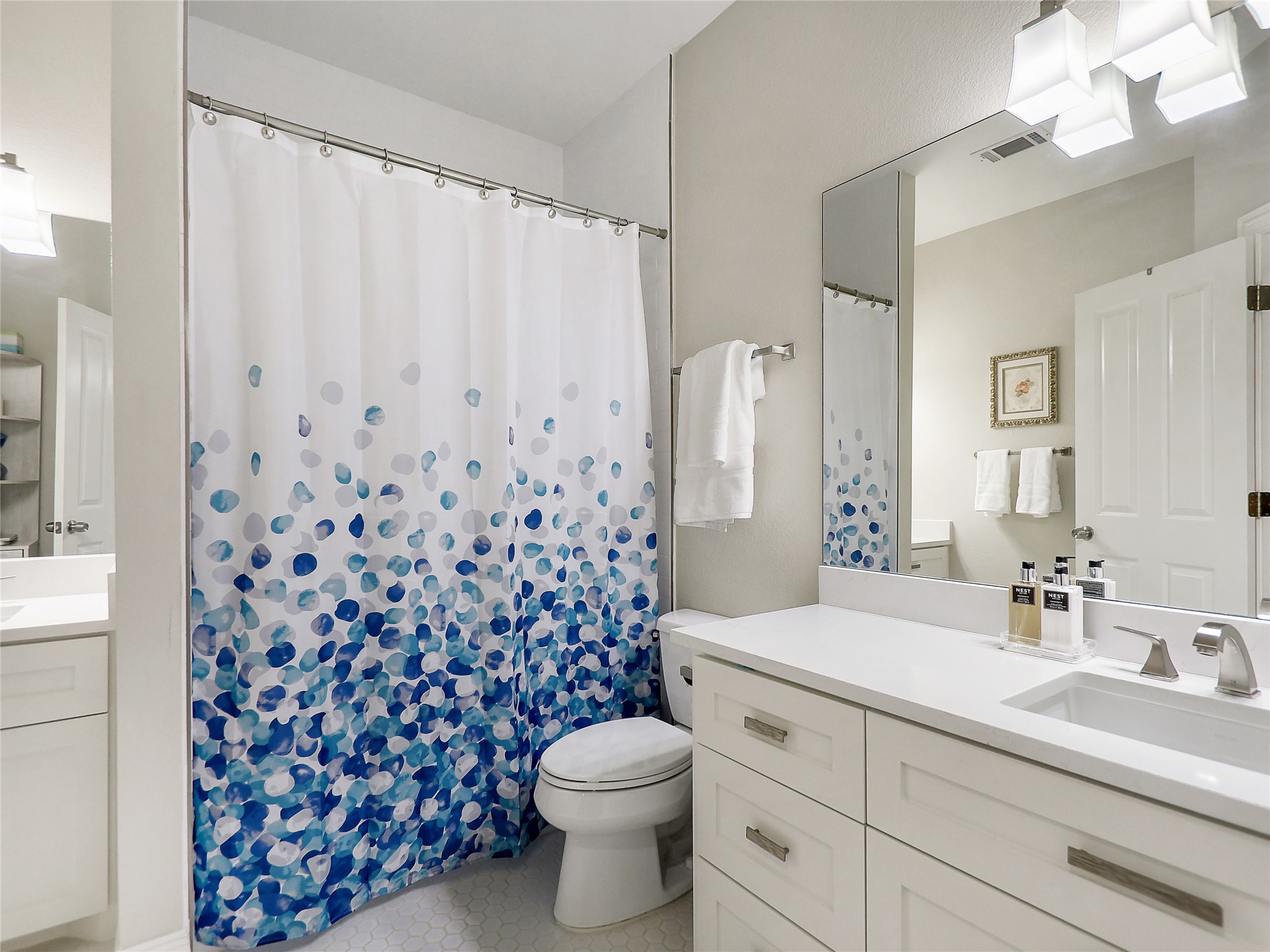 1910 Rue De St Tropez, Unit 4 Austin, TX 78746 - Photo 10 of 27 Full bath with vanity and curtained shower
