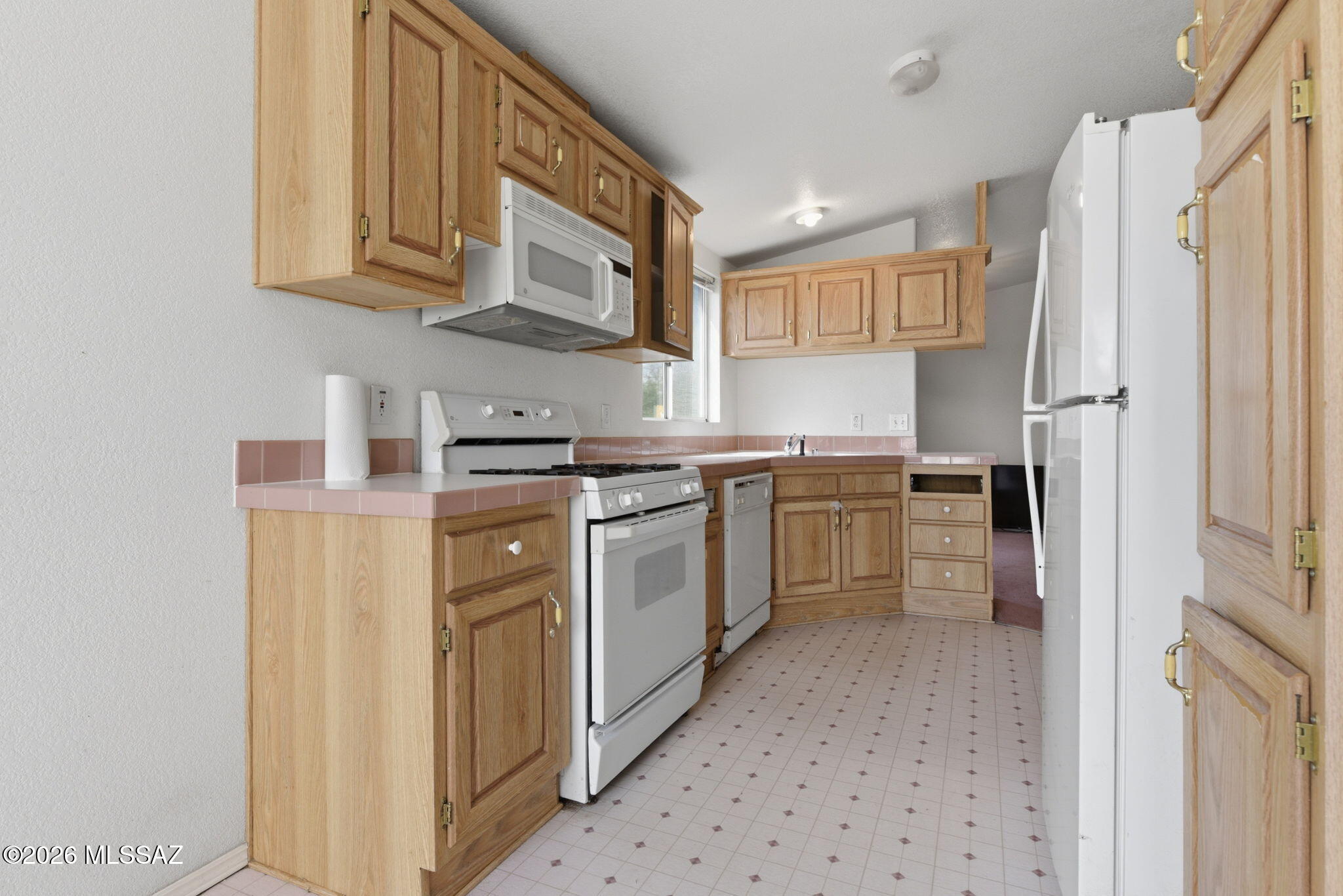 1930 Red Rock Road Dragoon, AZ 85609 - Photo 11 of 29 a kitchen with a sink a stove a refrigerator and cabinets