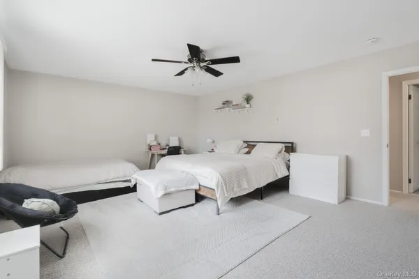 a bed room with furniture and a ceiling fan