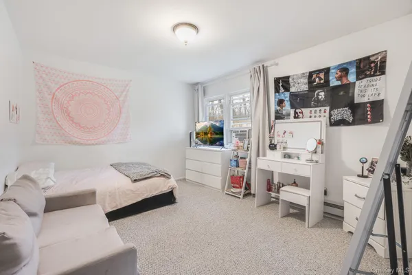 a bedroom with furniture and a book shelf