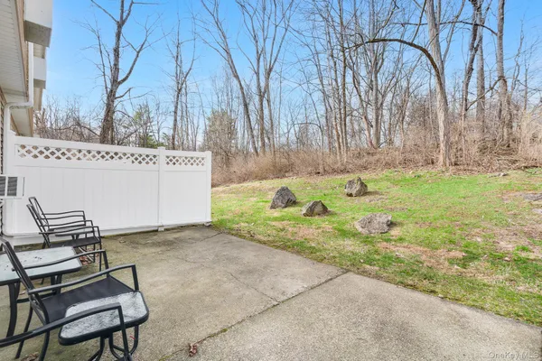 a backyard of a house with table and chairs