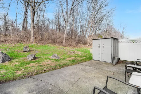 a backyard of a house with yard and trampoline