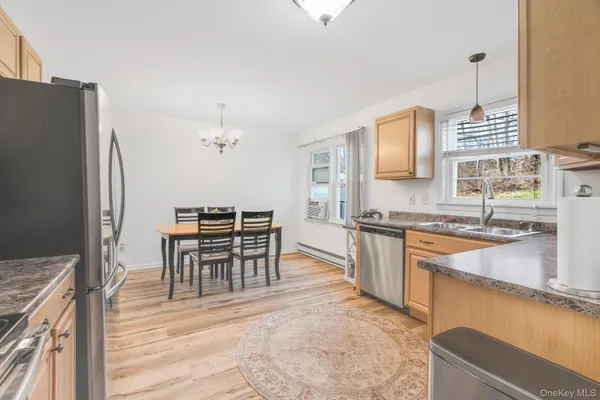 a kitchen with granite countertop a sink cabinets and stainless steel appliances