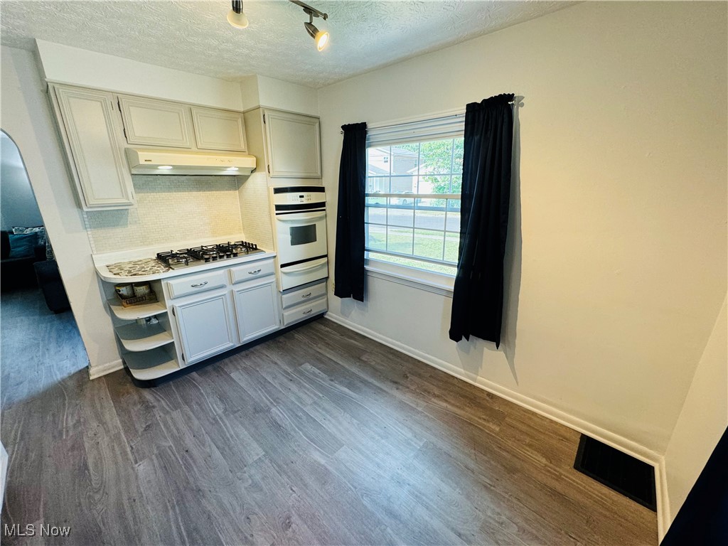 930 Reed Avenue Akron, OH 44306 - Photo 9 of 23 Kitchen featuring dark wood-type flooring, white oven, gray cabinets, a textured ceiling, and stainless steel gas stovetop