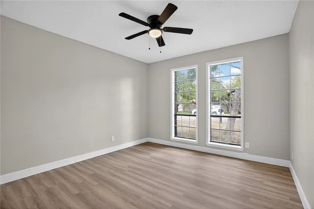 wooden floor in an empty room with a window