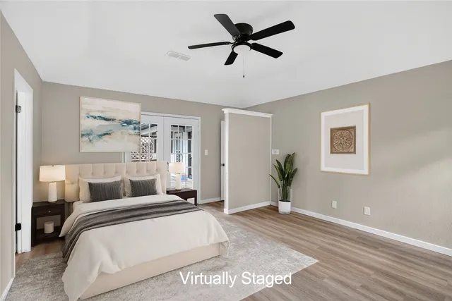 a bedroom with a large bed and a chandelier