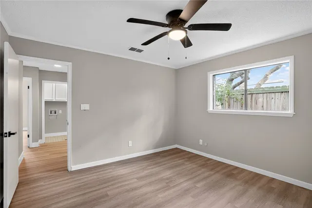 a bedroom with a large bed and wooden floor