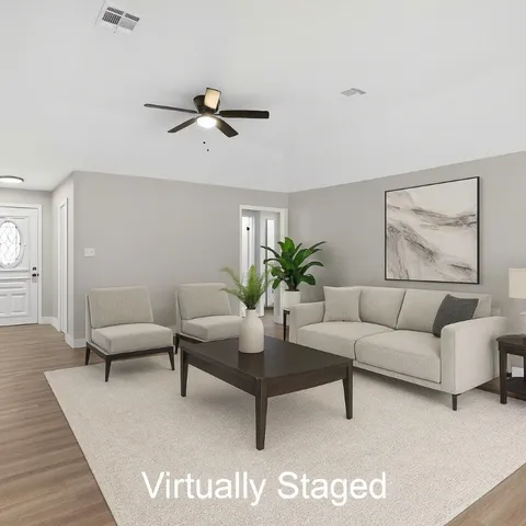 a living room with furniture and a potted plant