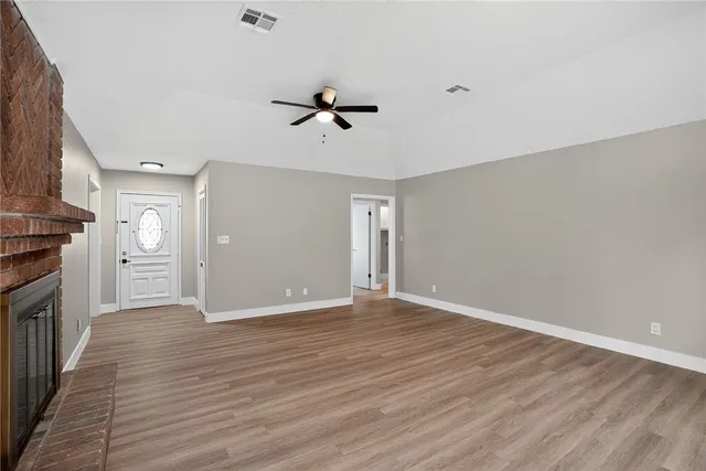 a view of a kitchen with a dishwasher and wooden floor