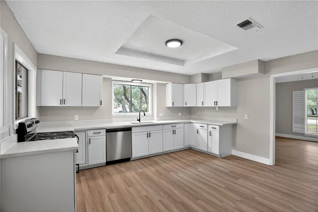 a kitchen with a white cabinets stove and sink
