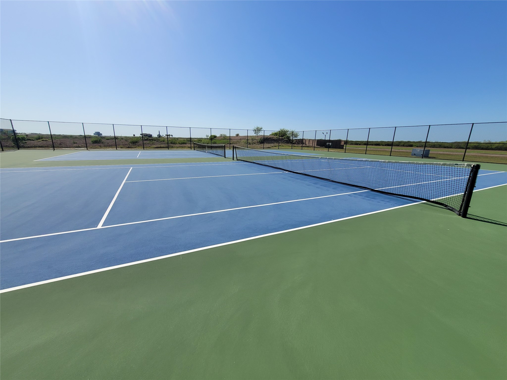 3225 Bay Rdg Drive Palacios, TX 77465 - Photo 9 of 15 a tennis court that has trees in the background